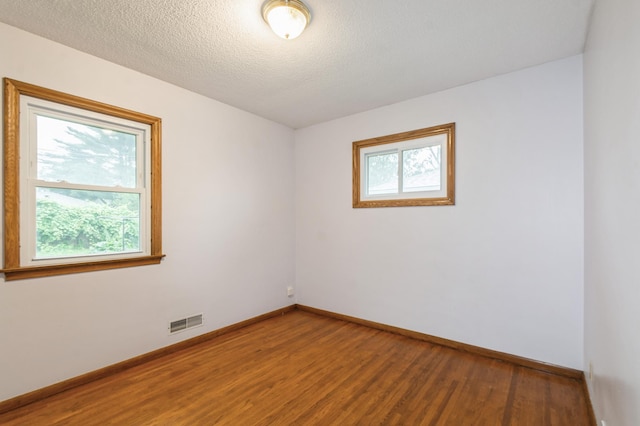 1501 100th St, Bloomington, MN 55431 - spare room featuring wood finished floors and a textured ceiling