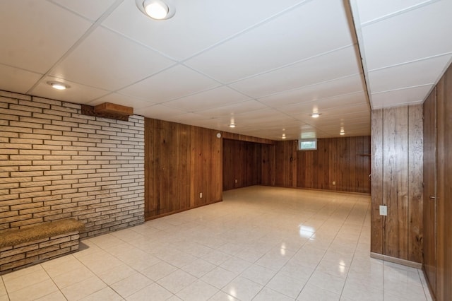 1501 100th St, Bloomington, MN 55431 - finished basement featuring wooden walls, a drop ceiling, and brick wall