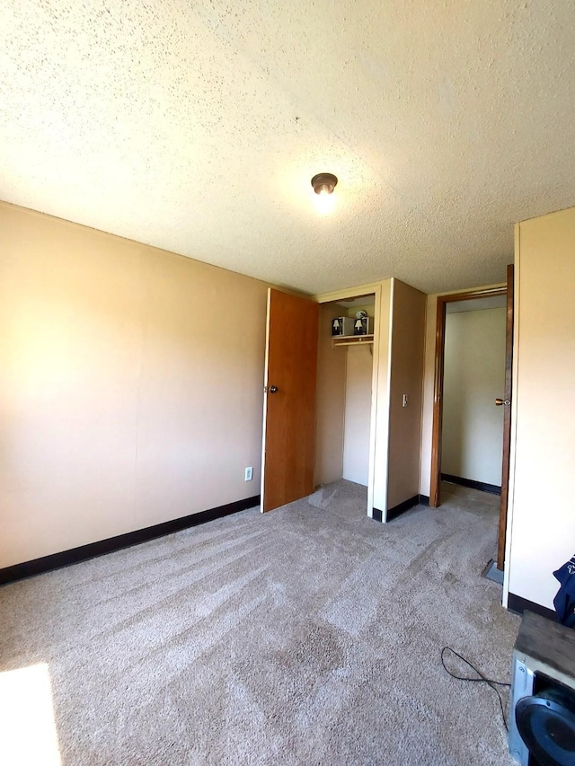 1329 US Highway 8, Balsam Lake, WI 54001 - unfurnished bedroom with carpet floors, a textured ceiling, and a closet