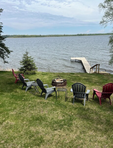 33252 Librarian Ln, Laporte, MN 56461 - view of green lawn with an outdoor fire pit, a water view, and a dock