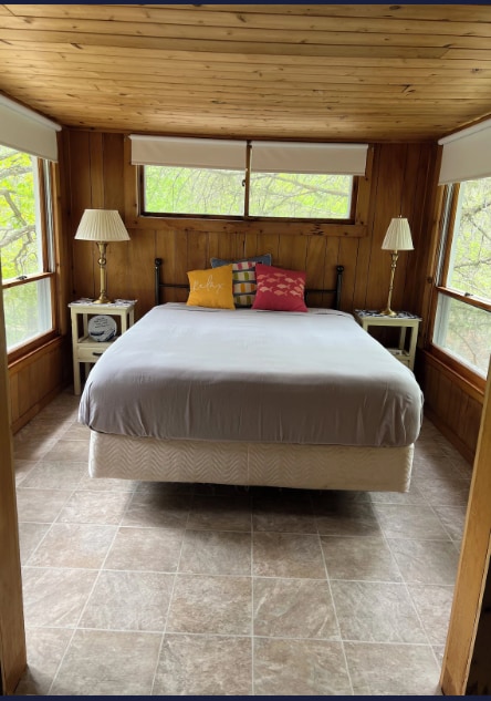 33252 Librarian Ln, Laporte, MN 56461 - bedroom with wooden ceiling, wood walls, and light stone finish floors