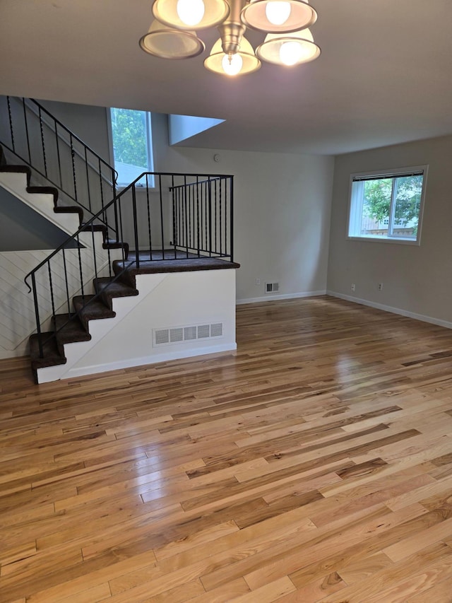 3615 Mckinley St NE, Minneapolis, MN 55418 - unfurnished living room featuring wood finished floors and stairs