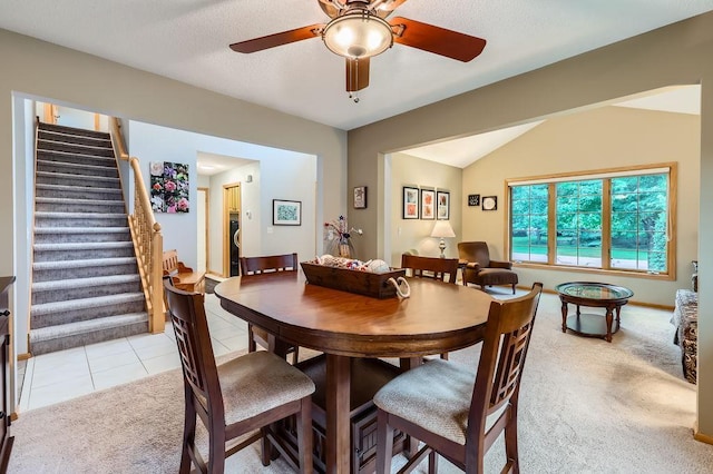14078 Quince St NW, Andover, MN 55304 - dining room with light colored carpet, a ceiling fan, stairway, light tile patterned floors, and lofted ceiling