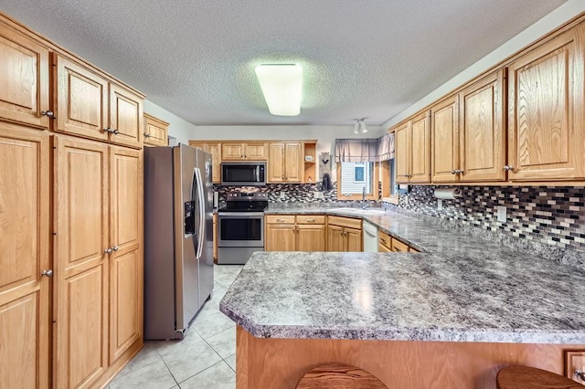 14078 Quince St NW, Andover, MN 55304 - kitchen with stainless steel appliances, a peninsula, backsplash, light tile patterned floors, and a textured ceiling