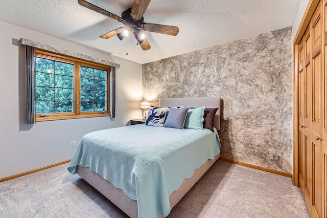 14078 Quince St NW, Andover, MN 55304 - bedroom featuring a textured ceiling, light colored carpet, an accent wall, a ceiling fan, and wallpapered walls