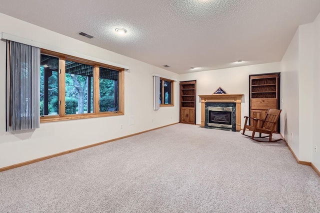 14078 Quince St NW, Andover, MN 55304 - unfurnished living room with carpet floors, a textured ceiling, and a fireplace with flush hearth