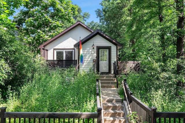 610 34th Ave N, Minneapolis, MN 55412 - bungalow-style home with stairs and stucco siding