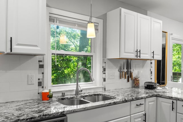 610 34th Ave N, Minneapolis, MN 55412 - kitchen featuring white cabinets and healthy amount of natural light