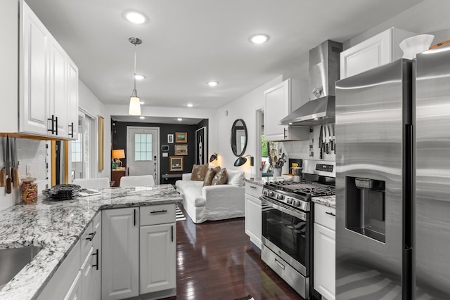 610 34th Ave N, Minneapolis, MN 55412 - kitchen with appliances with stainless steel finishes, wall chimney exhaust hood, a peninsula, white cabinets, and recessed lighting