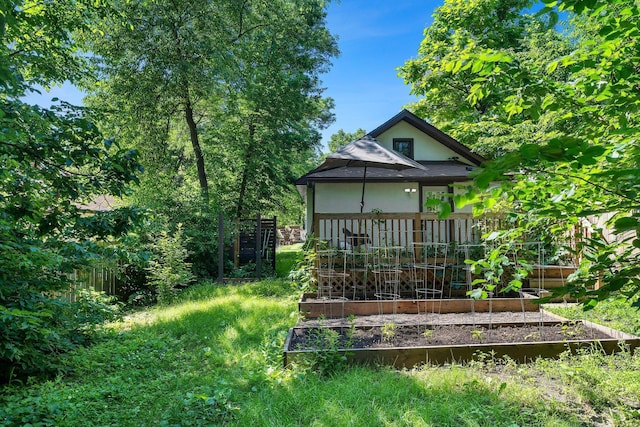 610 34th Ave N, Minneapolis, MN 55412 - back of house featuring a vegetable garden and stucco siding