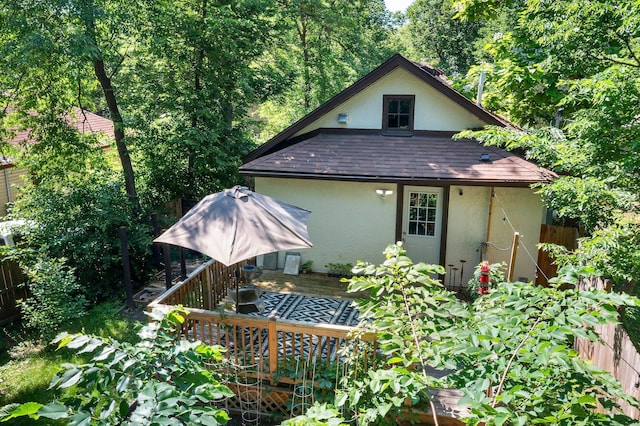610 34th Ave N, Minneapolis, MN 55412 - back of property with stucco siding, roof with shingles, and a deck