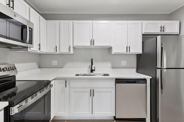 10501 Cedar Lake Rd Unit 515, Minnetonka, MN 55305 - kitchen with stainless steel appliances, white cabinets, light countertops, and crown molding
