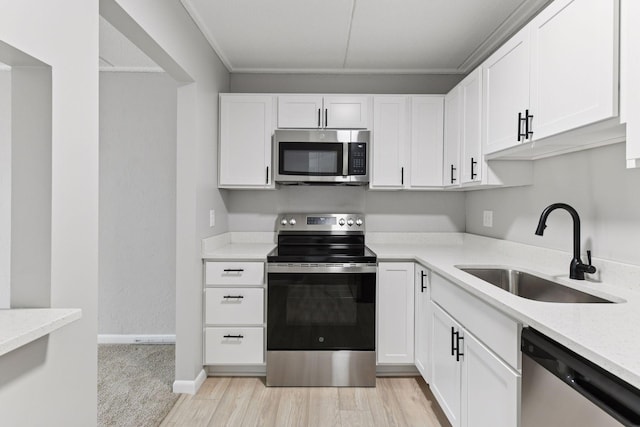 10501 Cedar Lake Rd Unit 515, Minnetonka, MN 55305 - kitchen with appliances with stainless steel finishes, white cabinets, and light wood-style floors