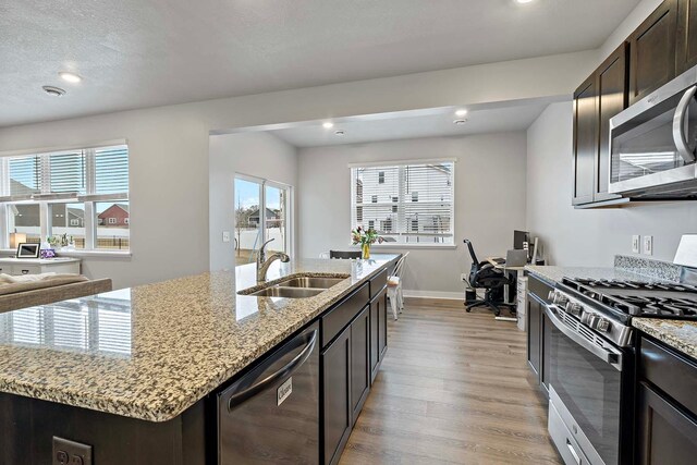11242 131st Cir N, Dayton, MN 55327 - kitchen with stainless steel appliances, light wood-style flooring, recessed lighting, plenty of natural light, and an island with sink