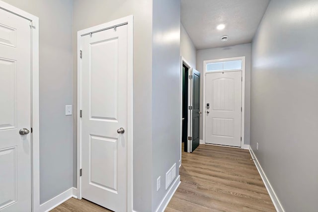 11242 131st Cir N, Dayton, MN 55327 - corridor with light wood-style floors and a textured ceiling