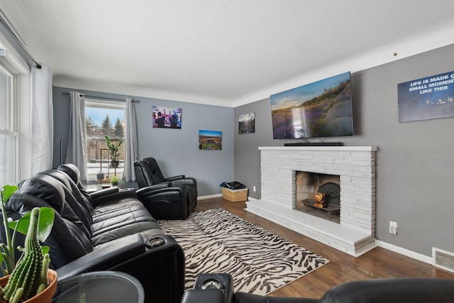 7632 Dupont Ave S, Richfield, MN 55423 - living area featuring wood finished floors and a lit fireplace