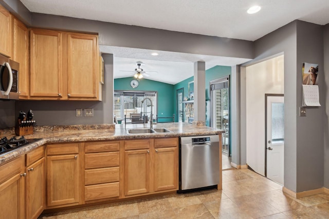 7632 Dupont Ave S, Richfield, MN 55423 - kitchen featuring appliances with stainless steel finishes, vaulted ceiling, ceiling fan, healthy amount of natural light, and a peninsula