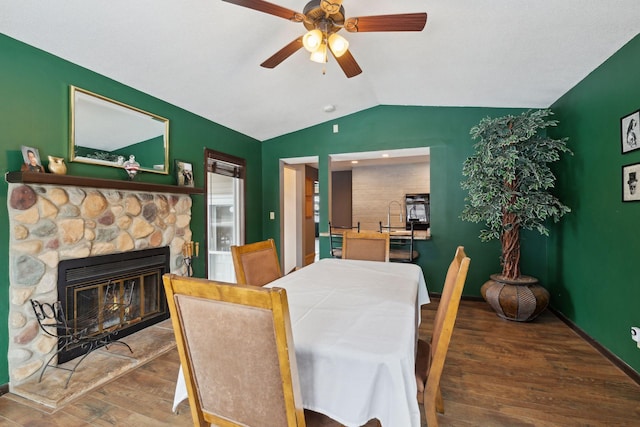 7632 Dupont Ave S, Richfield, MN 55423 - dining room featuring wood finished floors, lofted ceiling, ceiling fan, and a stone fireplace