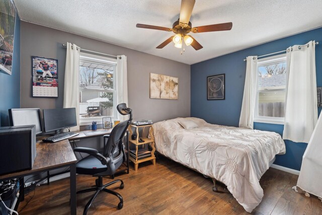 7632 Dupont Ave S, Richfield, MN 55423 - bedroom featuring multiple windows, wood finished floors, an office area, a textured ceiling, and ceiling fan