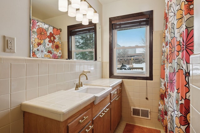 7632 Dupont Ave S, Richfield, MN 55423 - bathroom with tile walls, vanity, and curtained shower