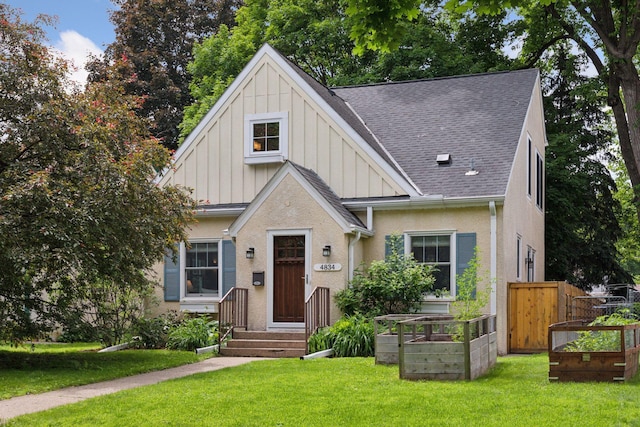 4834 33rd Ave S, Minneapolis, MN 55417 - view of front of home with board and batten siding, roof with shingles, and a vegetable garden