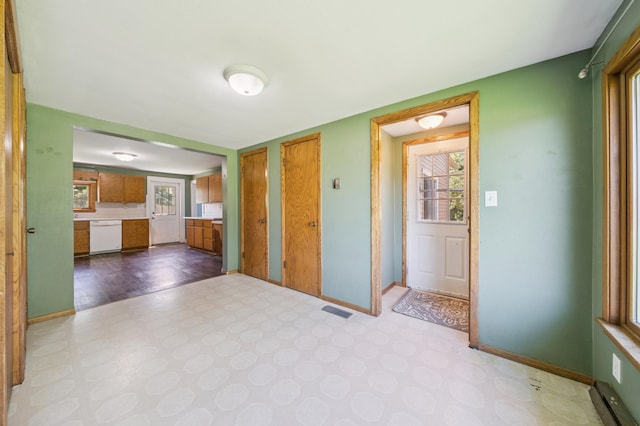 N3752 County Road K, Trenton Twp, WI 54014 - unfurnished living room featuring tile patterned floors and baseboards
