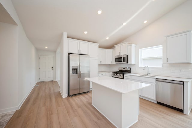 11730 71st St NE, Otsego, MN 55301 - kitchen featuring stainless steel appliances, decorative backsplash, white cabinets, light wood-type flooring, and recessed lighting