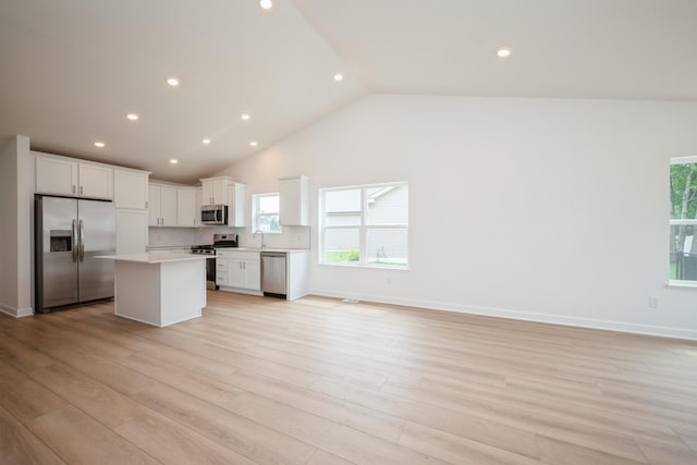 11730 71st St NE, Otsego, MN 55301 - kitchen with stainless steel appliances, a kitchen island, open floor plan, light countertops, and white cabinets