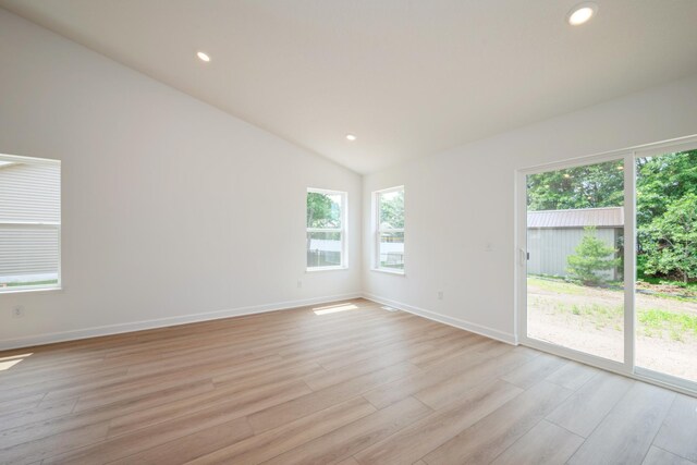 11730 71st St NE, Otsego, MN 55301 - spare room featuring light wood-style floors, vaulted ceiling, and recessed lighting