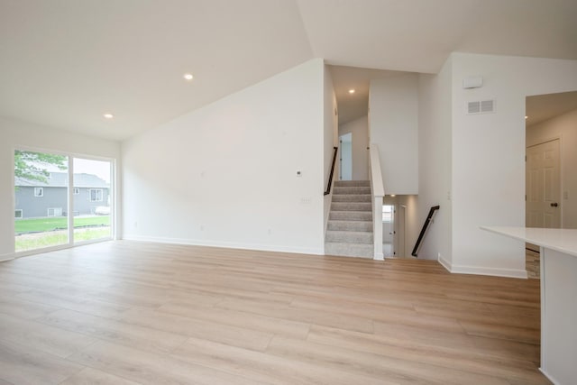 11730 71st St NE, Otsego, MN 55301 - unfurnished living room featuring light wood-style flooring, recessed lighting, stairway, and vaulted ceiling