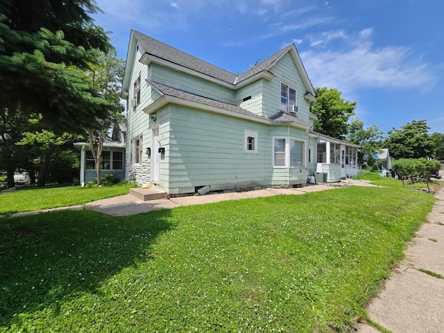35 Front Ave, Saint Paul, MN 55117 - view of side of property featuring a sunroom, a lawn, and a shingled roof