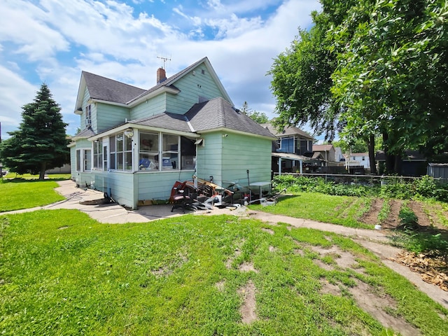 35 Front Ave, Saint Paul, MN 55117 - view of home's exterior featuring a sunroom, a shingled roof, a chimney, and a patio