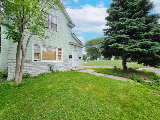 35 Front Ave, Saint Paul, MN 55117 - view of home's exterior featuring stone siding and a yard