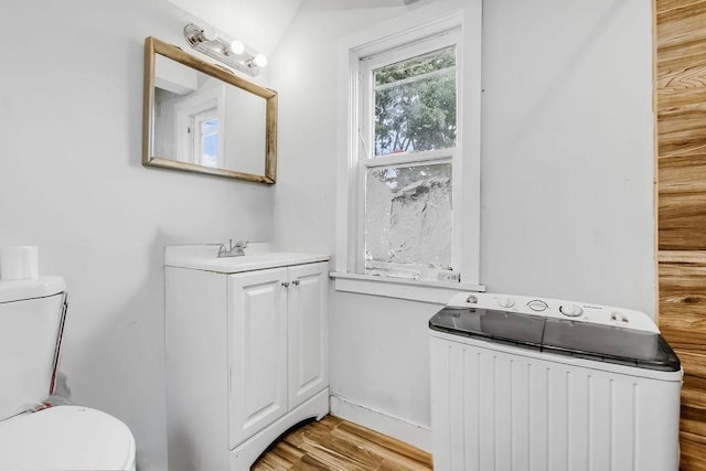 35 Front Ave, Saint Paul, MN 55117 - bathroom featuring vanity, wood finished floors, and radiator