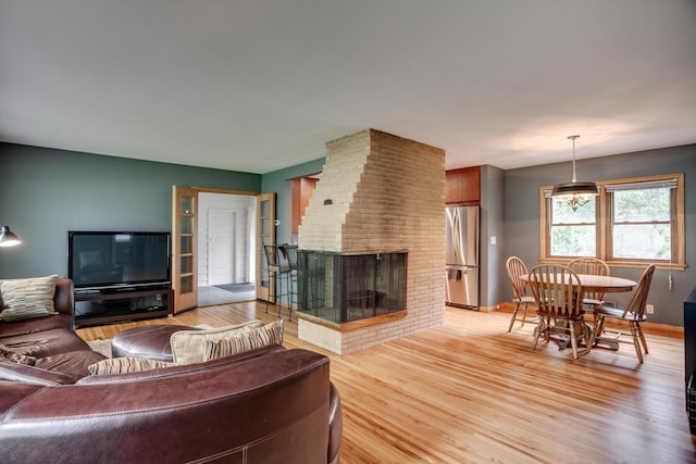1030 Idaho Ave N, Golden Valley, MN 55427 - living room featuring light wood-style floors and a fireplace