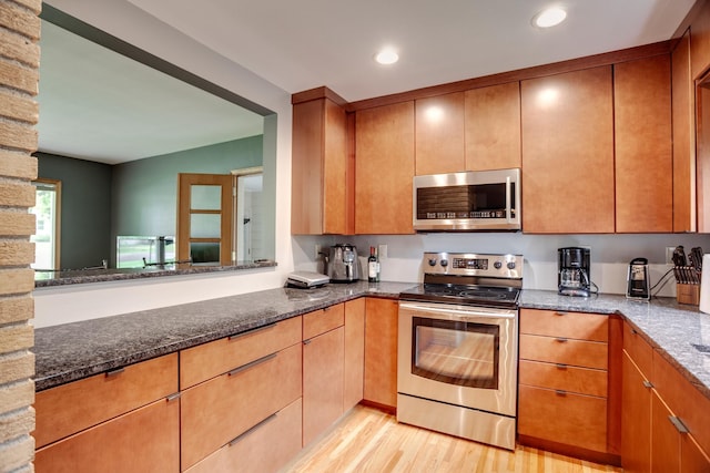 1030 Idaho Ave N, Golden Valley, MN 55427 - kitchen featuring appliances with stainless steel finishes, light wood-style flooring, dark stone countertops, and recessed lighting