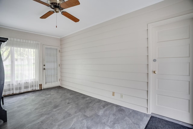 1030 Idaho Ave N, Golden Valley, MN 55427 - unfurnished room with ceiling fan, crown molding, and wooden walls