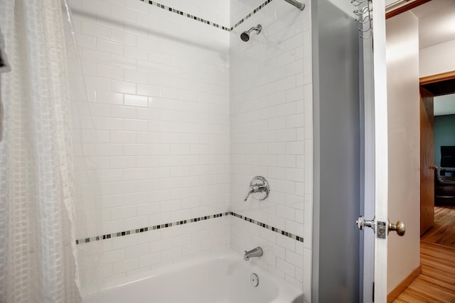 1030 Idaho Ave N, Golden Valley, MN 55427 - full bathroom featuring shower / bath combo and wood finished floors