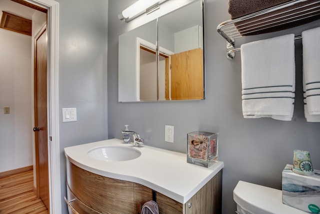1030 Idaho Ave N, Golden Valley, MN 55427 - half bathroom featuring vanity and wood finished floors