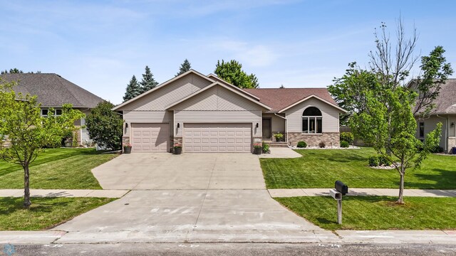1421 55th Ave S, Fargo, ND 58104 - single story home featuring an attached garage, driveway, and a front lawn