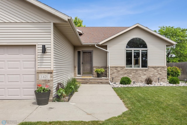 1421 55th Ave S, Fargo, ND 58104 - doorway to property with brick siding, a shingled roof, and a garage