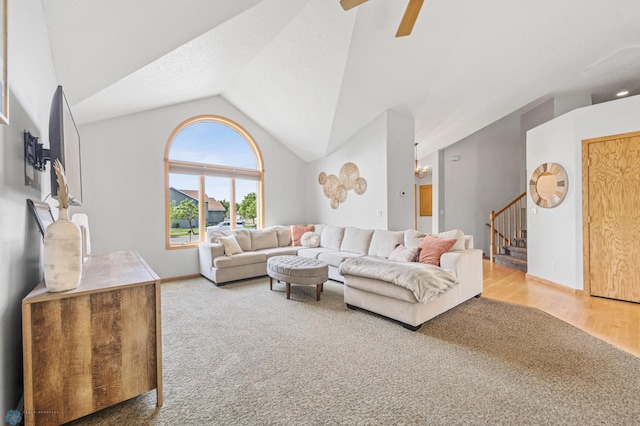 1421 55th Ave S, Fargo, ND 58104 - living room featuring lofted ceiling, stairway, ceiling fan, carpet flooring, and wood finished floors