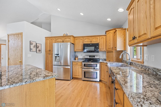 1421 55th Ave S, Fargo, ND 58104 - kitchen with appliances with stainless steel finishes, light stone counters, light wood-style floors, high vaulted ceiling, and recessed lighting