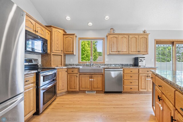 1421 55th Ave S, Fargo, ND 58104 - kitchen with appliances with stainless steel finishes, light wood-style floors, light stone countertops, and recessed lighting