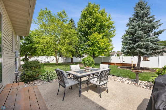 1421 55th Ave S, Fargo, ND 58104 - fenced backyard with outdoor dining space and a patio area