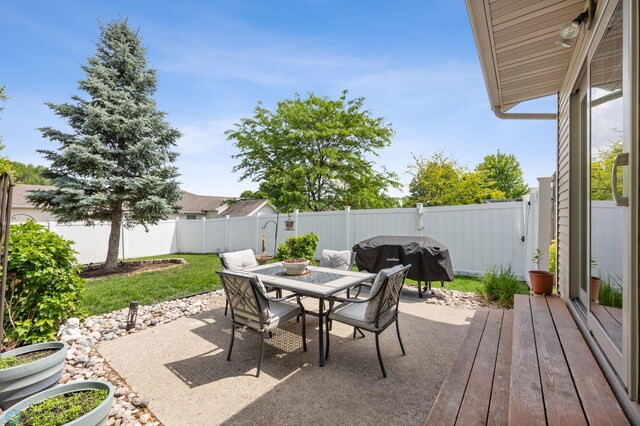 1421 55th Ave S, Fargo, ND 58104 - fenced backyard featuring outdoor dining area, a patio, and grilling area