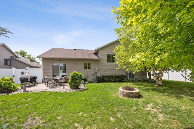 1421 55th Ave S, Fargo, ND 58104 - rear view of house with a fire pit, a patio, and roof with shingles