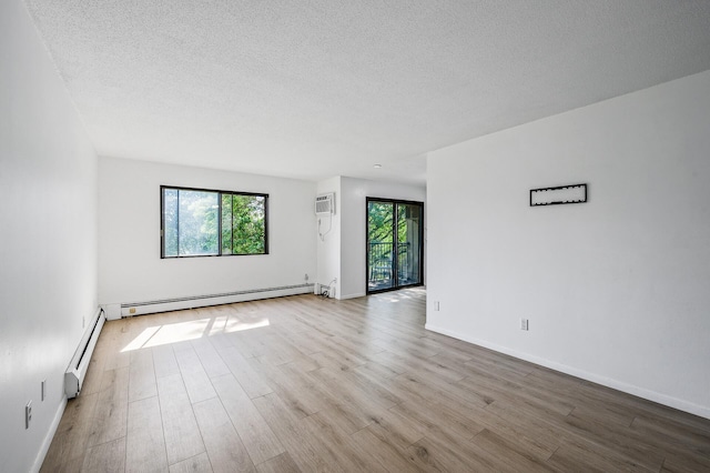4101 Parklawn Ave Unit 320, Edina, MN 55435 - unfurnished room featuring baseboard heating, healthy amount of natural light, wood finished floors, and a textured ceiling