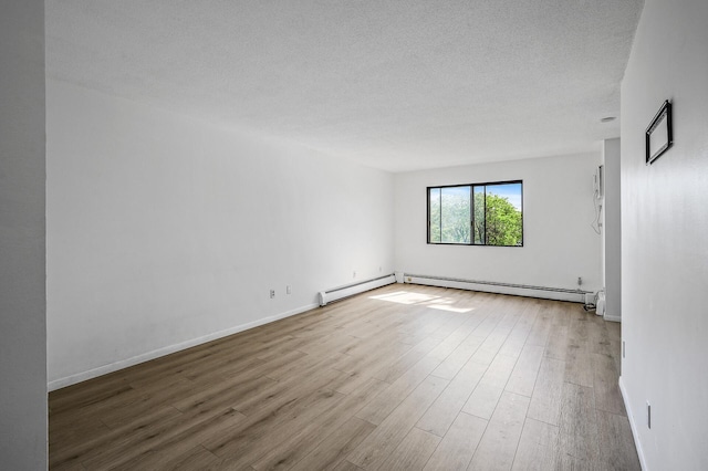 4101 Parklawn Ave Unit 320, Edina, MN 55435 - unfurnished room with a baseboard radiator, wood finished floors, and a textured ceiling