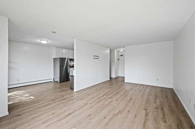4101 Parklawn Ave Unit 320, Edina, MN 55435 - spare room featuring a baseboard heating unit and light wood-style flooring
